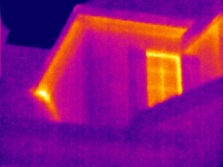 Infrared thermal image of heat loss through attic and roof ventilation.